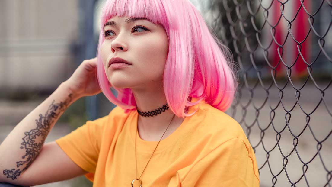 young girl with pink hair and arm tatoo